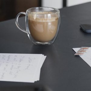 A hand writing a letter